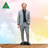Man in a gray suit standing on a wooden floor with a colorful background and 'Australian Made' logo.